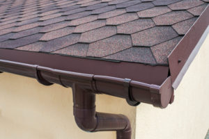 Half-round gutters installed at the corner of a roof by IBP of West Palm.